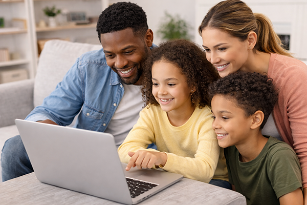 Family looking at laptop