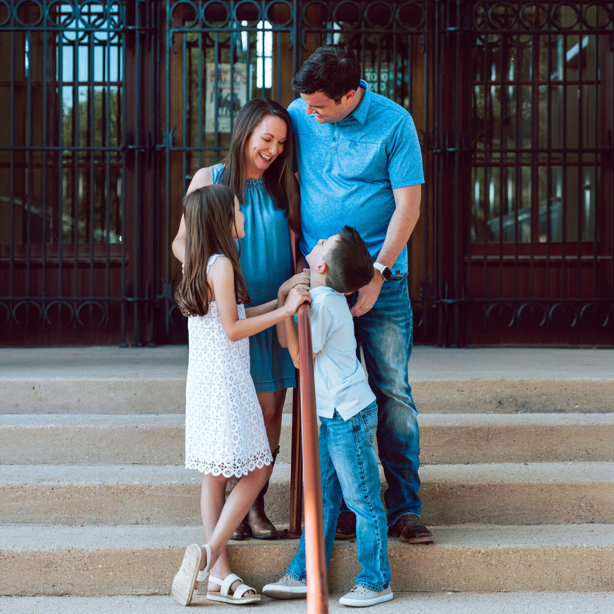 A happy family standing on a staircase