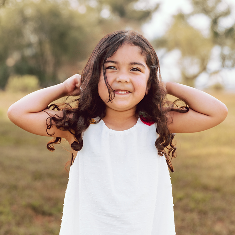 Little girl making muscles