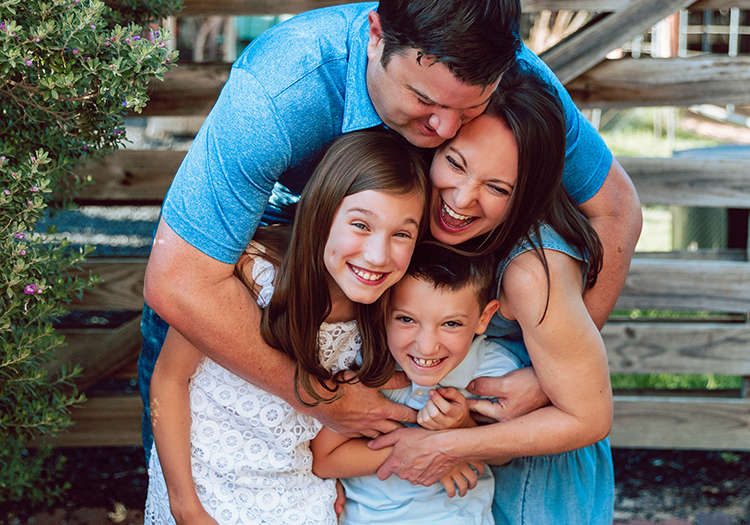 Family hugging and laughing