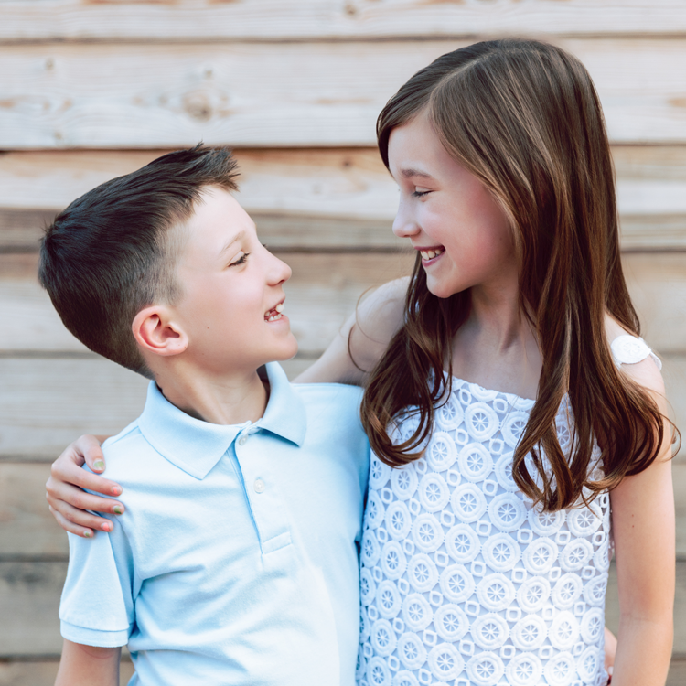 Daughter and son looking at each other and smiling