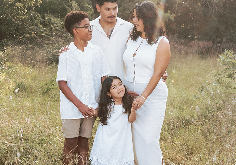 Family standing in the park long grass