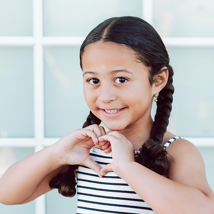 Girl making heart hands