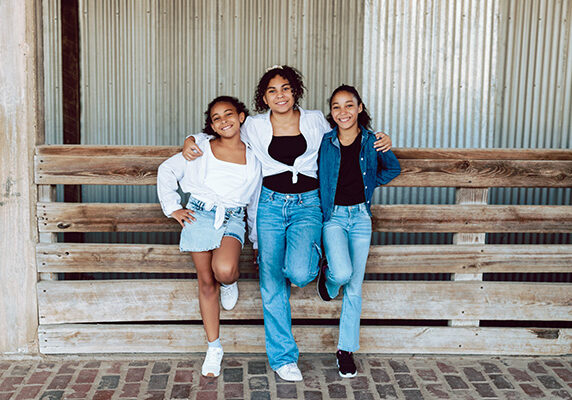 Sisters standing together and smiling